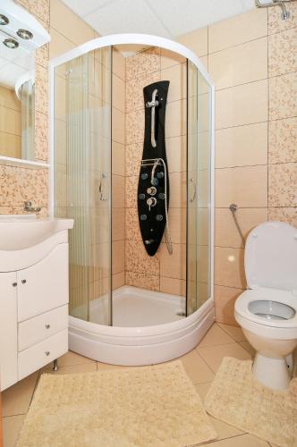 a bathroom with a shower with a black guitar hanging at Apartment Villa Marija in Tivat
