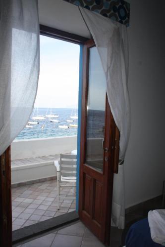 a door to a room with a view of the ocean at Da Nino sul mare Filicudi in Filicudi