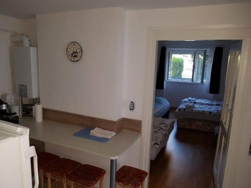 a kitchen with a counter and a room with a bed at Feszty-fészek Vendégház in Tiszafüred