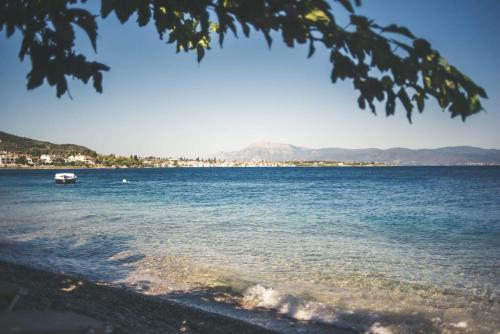 a view of a large body of water with a boat at Teatro Deluxe Rooms in Kato Rodini