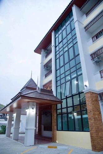 a large white building with a large window at Dusita Residence ดุสิตา เรสซิเดนซ์ in Phetchabun