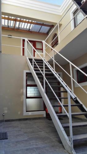 a spiral staircase in a building with a window at Bergsig Selfcatering in Gordonʼs Bay
