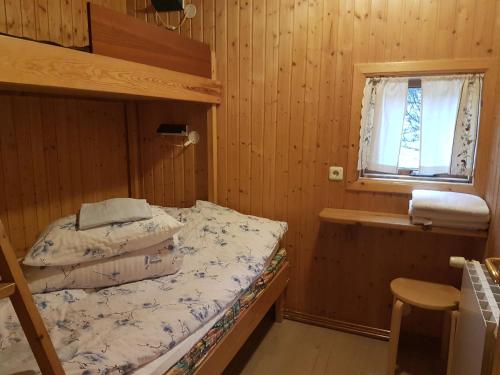 a bedroom with two bunk beds and a window at Ásólfsskáli Cottage in Ásólfsskáli