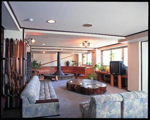 a living room with a couch and a coffee table at Villa Ichinose in Yamanouchi