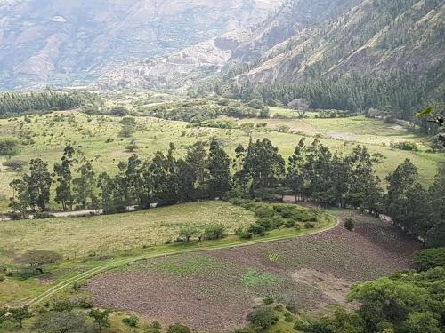 an aerial view of a valley with trees and a road at Hacienda Gonzabal in Loja