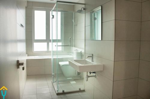 a bathroom with a sink and a glass shower at HomestayIpoh-Octagon in Ipoh