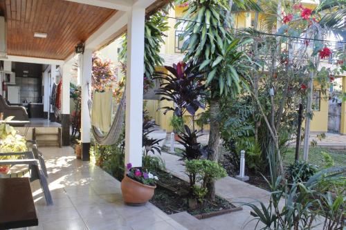a porch with a bunch of plants and flowers at Hospedaje Jose Gorgues in Puerto Iguazú