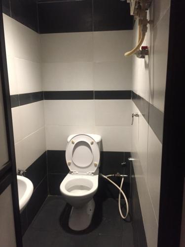 a bathroom with a toilet and a sink at Ophir Inn in Skudai