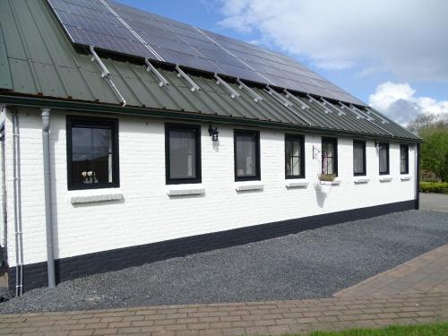 a white building with solar panels on it at B&B vakantieappartementen Dalerheugte in Dalerveen