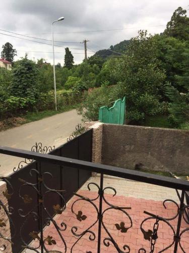 a balcony with a wrought iron fence and a road at Vacation Home Nukri in Gonio