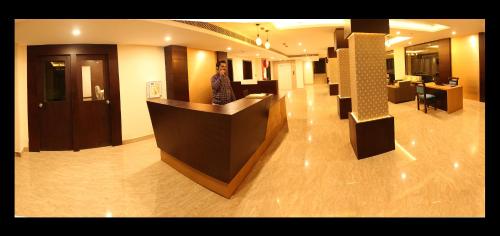 a man standing at a counter in a building at Hotel Yamuna in Adūr