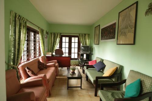 a living room with couches and chairs at Araliya Holiday Bungalow in Kandy