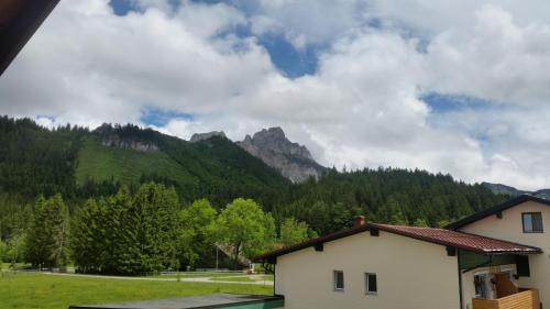 a house with a view of a mountain at Landhaus Aggenstein in Haldensee