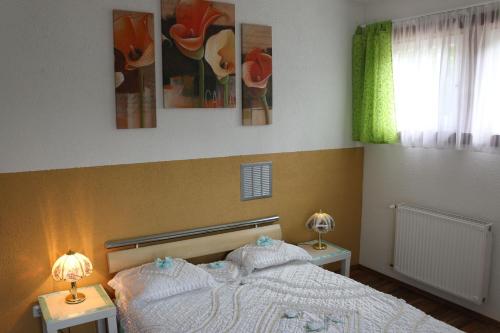a bedroom with a bed with two night stands and two lamps at Zur Alpenruhe in Seeboden