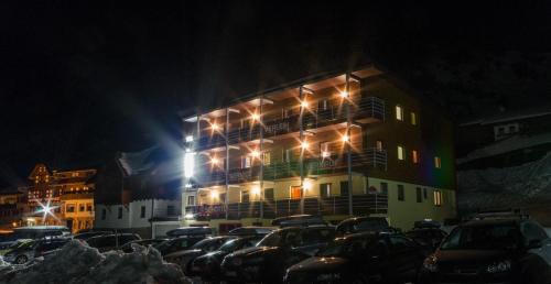 a parking lot in front of a building at night at Ferienwohnung Ski-Hans in Planneralm