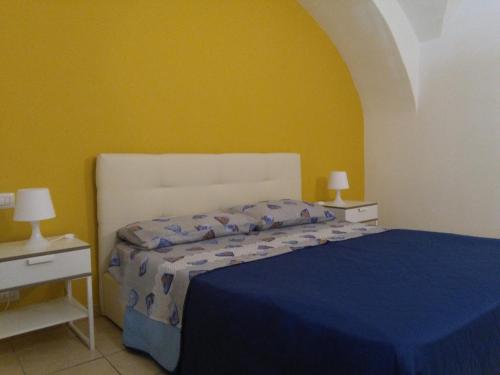 a bedroom with a bed and a yellow wall at Affaccio al barocco in Catania