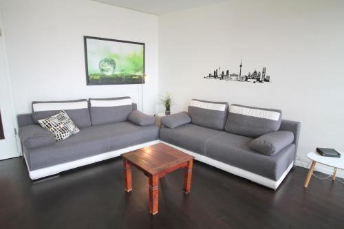 a living room with two couches and a coffee table at Holiday at Alexanderplatz Apartments in Berlin