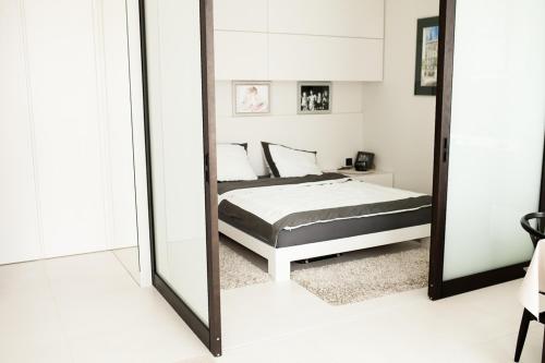 a bedroom with a bed and a large mirror at Okolnik Apartment in Warsaw