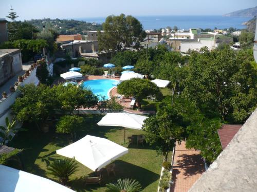 a view of a swimming pool with umbrellas at Hotel Savoia in Procida