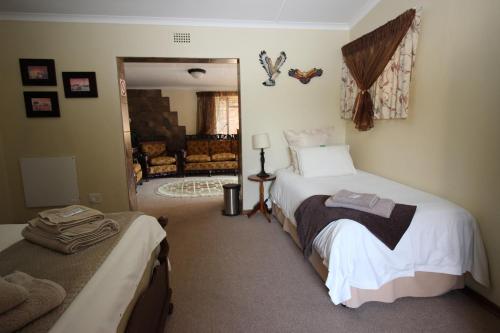 a bedroom with two beds and a living room at Waterfront Guest House in Carolina