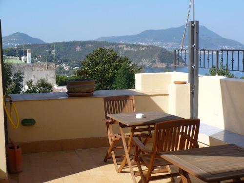 a patio with a table and chairs on a balcony at Hotel Savoia in Procida