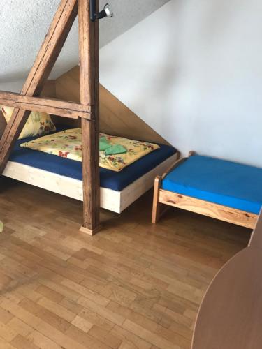 two bunk beds in a room with a wooden floor at Ferienwohnung Zeitler in Treuen