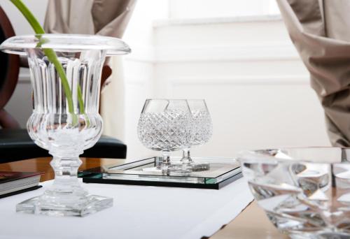 two clear glass vases sitting on a table at La Medusa Hotel - Dimora di Charme in Castellammare di Stabia