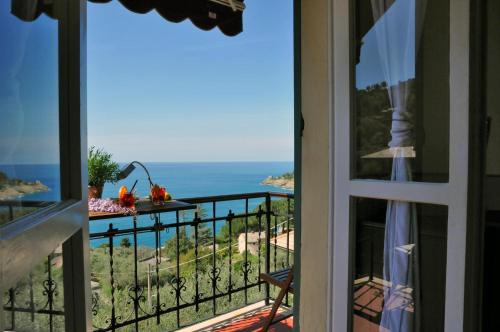 a room with a view of the ocean from a balcony at Hotel Villa Belvedere in Bonassola