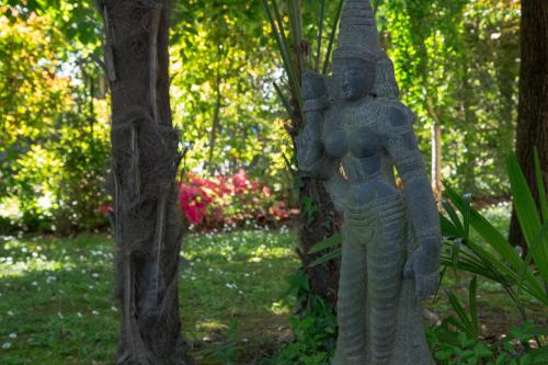 a statue in a garden next to two trees at Ca' delle palme in Martellago