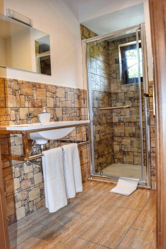 a bathroom with a sink and a shower at Heaven Guesthouse in Corbeni