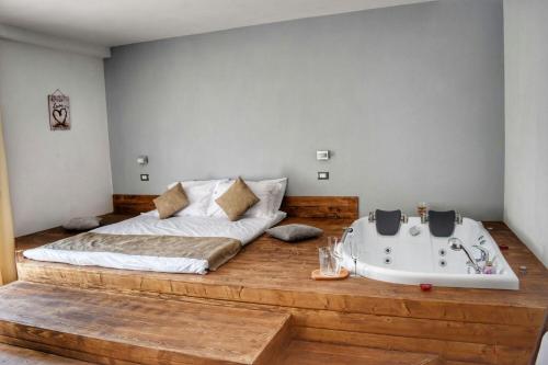 a bedroom with a bed and a bath tub at Heaven Guesthouse in Corbeni