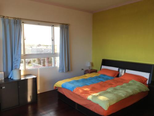 a bedroom with a large bed with a window at manor in Houli