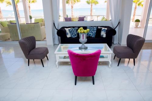 
a living room with a table and chairs at Sidari Beach Hotel in Sidari
