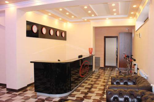 a lobby with a desk and a leather couch at Hotel For You in Yerevan