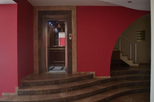 a staircase in a building with a red wall at Hotel Deniz Eceabat in Eceabat
