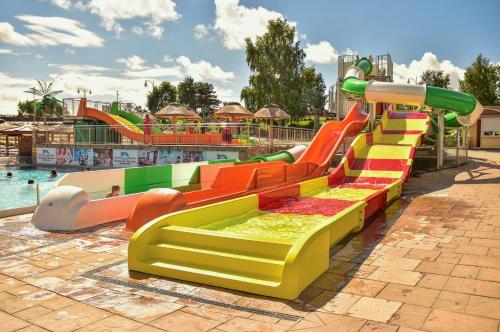 a water park with a colorful water slide at Aquapark Health Resort & Medical SPA Panorama Morska All Inclusive in Jarosławiec