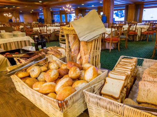 a display of bread and pastries in baskets at Sport Hotel Village in Soldeu