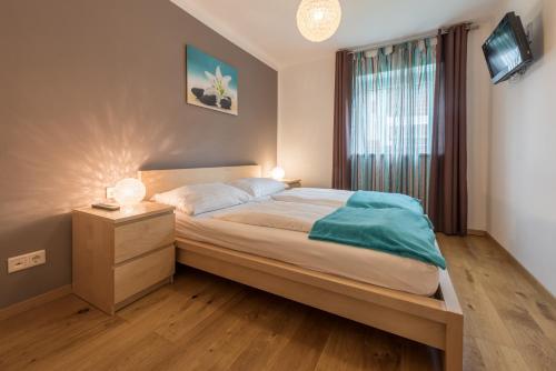 a bedroom with a large bed and a window at Almliesl MAIS-428 in Maishofen
