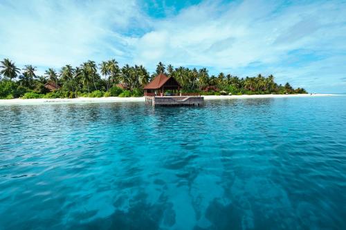 a small island with a house in the middle of the water at ROBINSON MALDIVES - Adults only in Gaafu Alifu Atoll