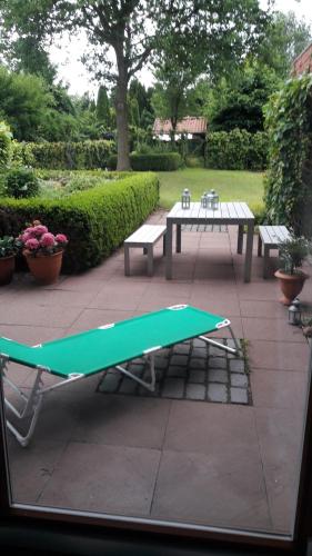 a green ping pong table and benches on a patio at Wiehen Inn in Heddinghausen