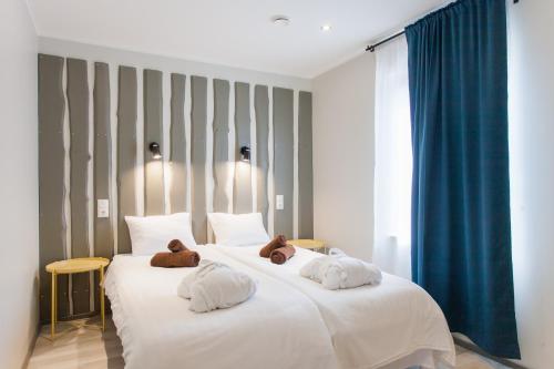 a bedroom with two beds with teddy bears on them at Johan Suites & Spa in Kuressaare