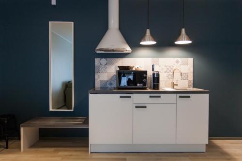 a kitchen with a counter with a microwave on it at Johan Suites & Spa in Kuressaare