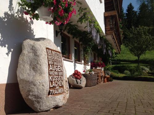 a large rock sitting outside of a building at Holzbildhauerei Kammerer in Triberg