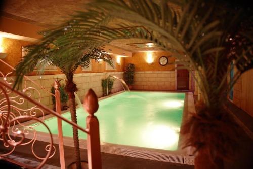a large swimming pool in a building with a clock at Posada-Spa Privilegio de Vara in Noja