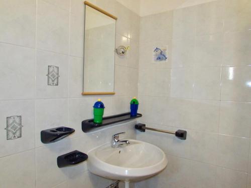 a bathroom with a sink and a mirror at Apartments Dražica 4 in Zubovići