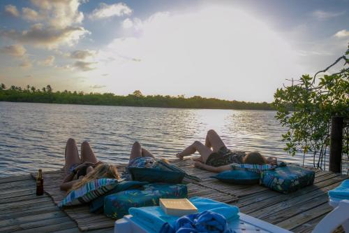 a group of people laying on a dock on the water at Tintipan Cabana SalSiPuedes in Tintipan Island