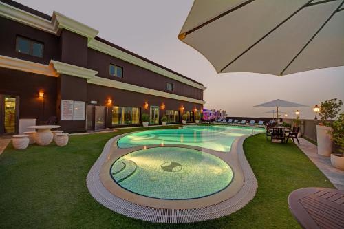 a large swimming pool in the middle of a building at Royal Ascot Hotel in Dubai