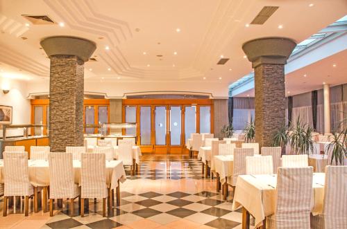 a banquet hall with white tables and chairs at Hotel Petka in Dubrovnik