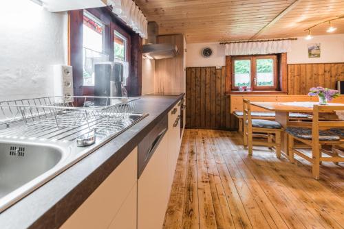 a kitchen with a sink and a dining table at Almliesl LUNG-495 in Annaberg im Lammertal
