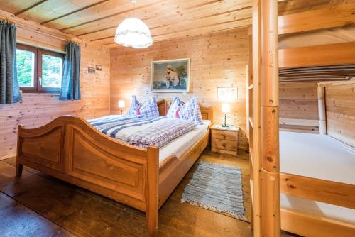a bedroom with a bed in a log cabin at Almliesl LUNG-495 in Annaberg im Lammertal